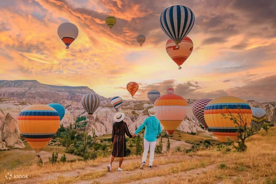Kolorowe balony unoszące się o świcie nad Doliną Miłości w Kapadocji